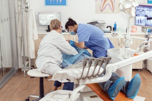 Dental professionals examining a patient during a procedure in a modern Dental Clinic