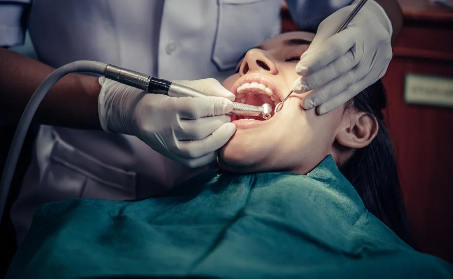 Patient receiving professional dental treatment at a modern dental clinic with advanced dental instruments.