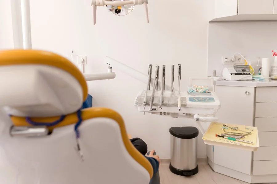 Modern dental clinic treatment room with dental chair and instruments