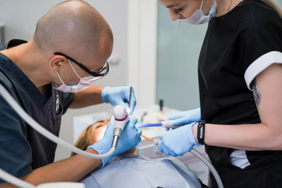 Dental surgeon performing a dental procedure in Greater Noida