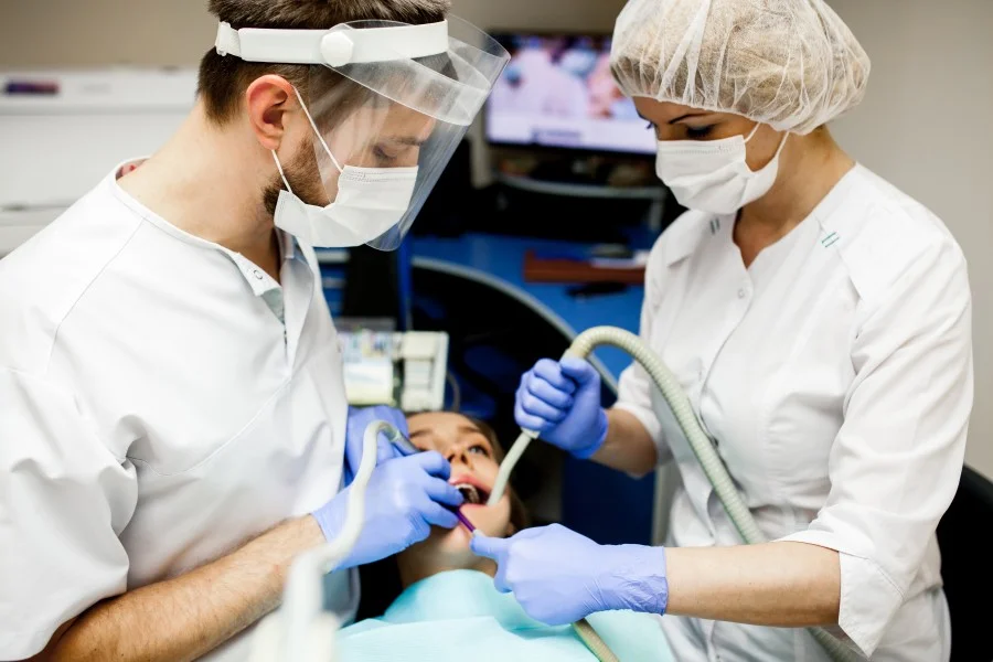 Dental surgeon in Greater Noida West performing a modern dental procedure with advanced equipment and professional assistance.