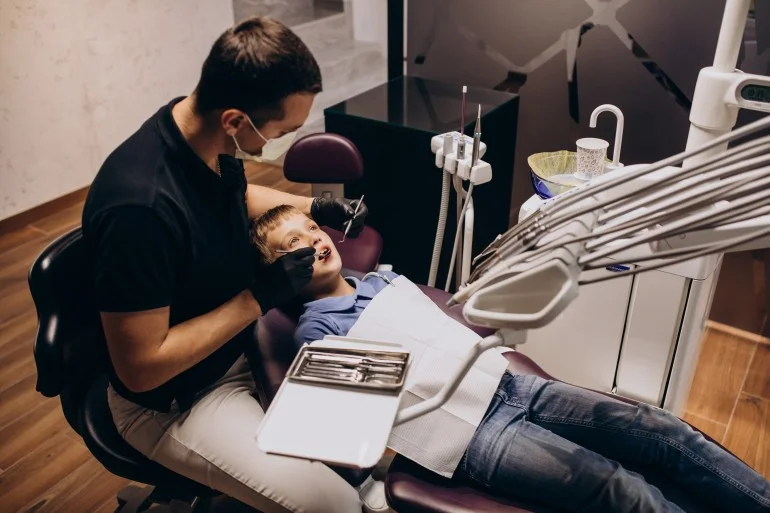 Dentist examining a child’s teeth during a dental checkup