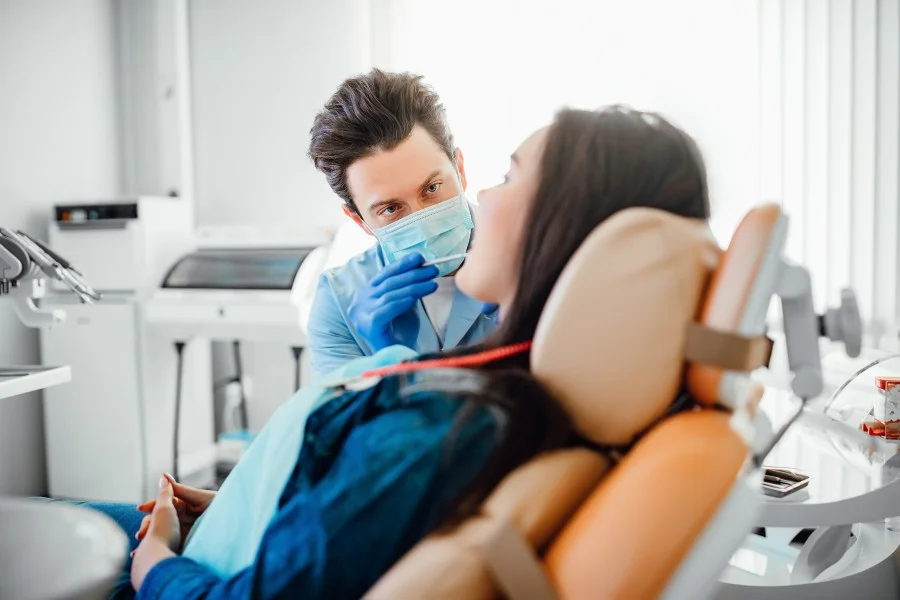 Dentist examining a patient during a dental check-up in a modern clinic