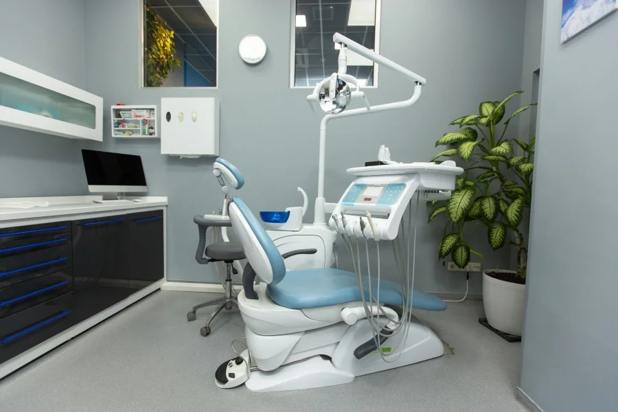 Modern dental clinic treatment room with dental chair and equipment